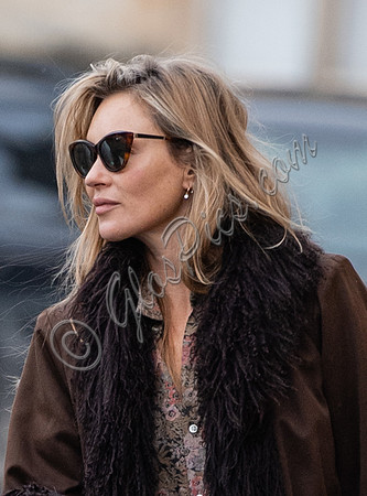Kate Moss alone wearing sunglasses