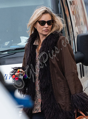 Kate Moss alone wearing sunglasses