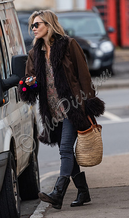 Kate Moss alone wearing sunglasses