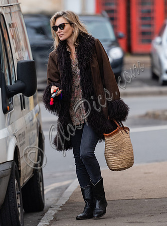 Kate Moss alone wearing sunglasses