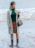 Rachel Weisz on beach carrying handbag, wearing 60's style pale green raincoat, headscarf and blue short wellington boots