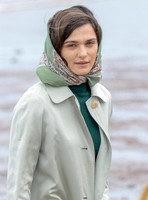 close up  of Rachel Weisz wearing 60's style pale green raincoat, headscarf