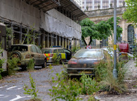 dystopian street scene with rusted out vehicles