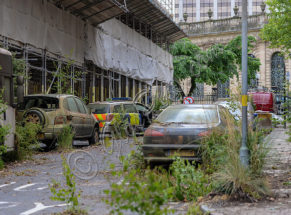dystopian street scene with rusted out vehicles