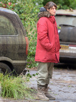 Gemma Arterton in red padded coat and oversized sunglasses