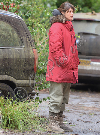 Gemma Arterton in red padded coat and oversized sunglasses