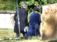 back view of Penelope WSilton and Douglas Reith in churchyard.