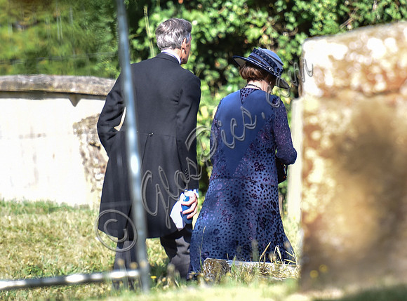 back view of Penelope WSilton and Douglas Reith in churchyard.