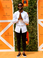 Tinie Tempah wearing white and black hands held in prayer