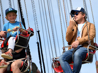 Jamie Oliver and Buddy Bear Maurice on fairground ride at Big Feastival