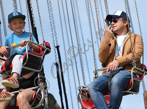 Jamie Oliver and Buddy Bear Maurice on fairground ride at Big Feastival