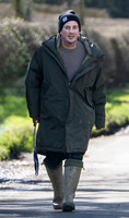 David Gardner wearing oversized coat and wellington boots