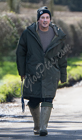David Gardner wearing oversized coat and wellington boots