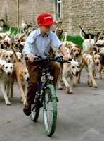 Prince Harry on bicycle with the Beaufort Hounds