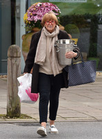 TV presenter Anne Robinson carrying ice buckets