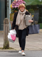 TV presenter Anne Robinson carrying ice buckets
