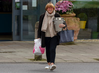 TV presenter Anne Robinson carrying ice buckets