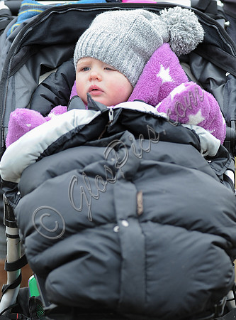 Mia Tindall close up in buggy wearing woolly hat.