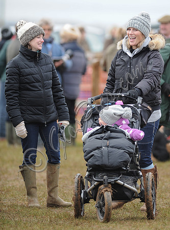 Female and Zara Tindall laughing, with daughter in buggy