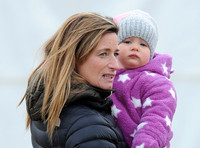 Dolly Maude holding Mia Tindall wearing pink and white onepiece suit and woolly hat