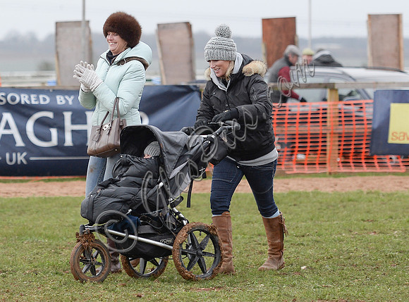 Zara Phillips pushing daughter in buggy wearing matching woolly hats and friend.