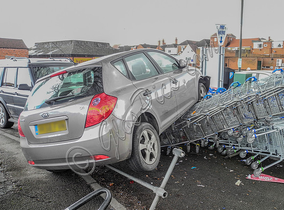 Car flattens bike stand and mounts row of trolleys in accident in Tewkesbury, Gloucestershire