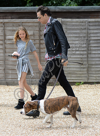 Jamie Hince with Lila Grace pixelated and Archie