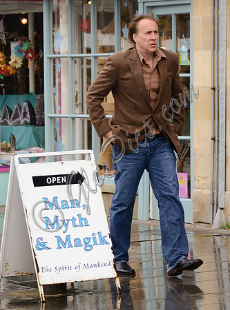 Nicolas Cage wandering around Glastonbury in the rain