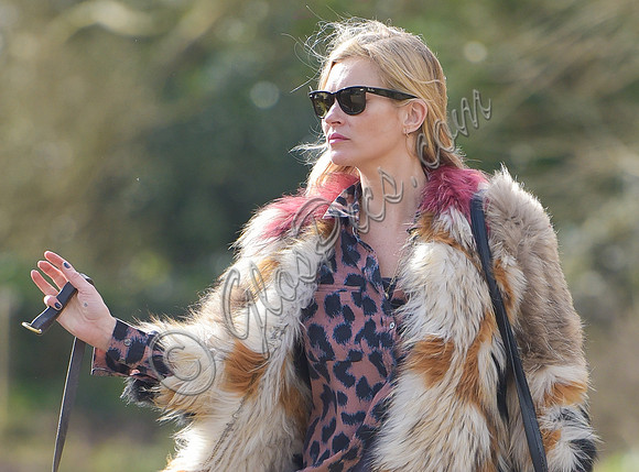 Kate Moss wearing Isabel Marant fur jacket and suede ankle boots with her dog Archie