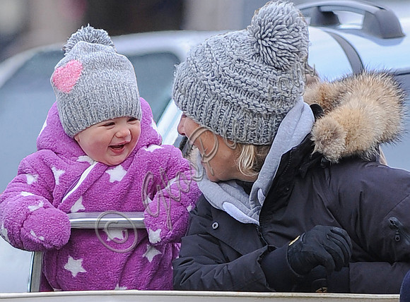Zara Phillips with Daughter both laughing and wearing matching woolly hats
