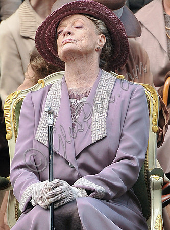 Maggie Smith as Violet Crawley wearing lilac sitting with nose in the air.