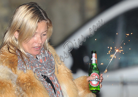 Kate  Moss with bottle of beer and a sparkler