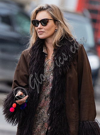 Kate Moss alone wearing sunglasses