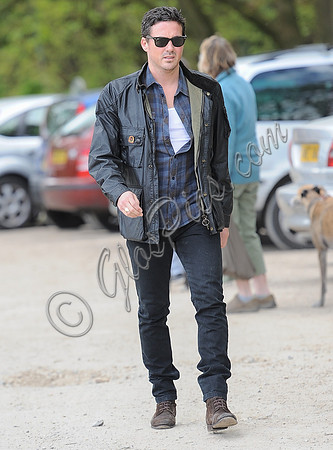 Dave Gardner wearing check shirt, leather jacket, black jeans and sunglasses at Badbury Clump, Oxfordshire