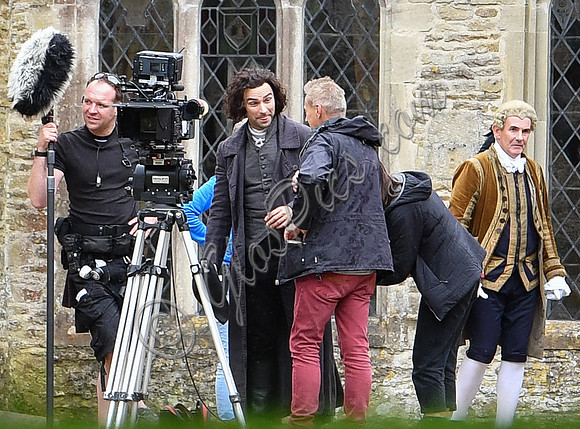Aidan Turner and crew members in front of Chavenage House