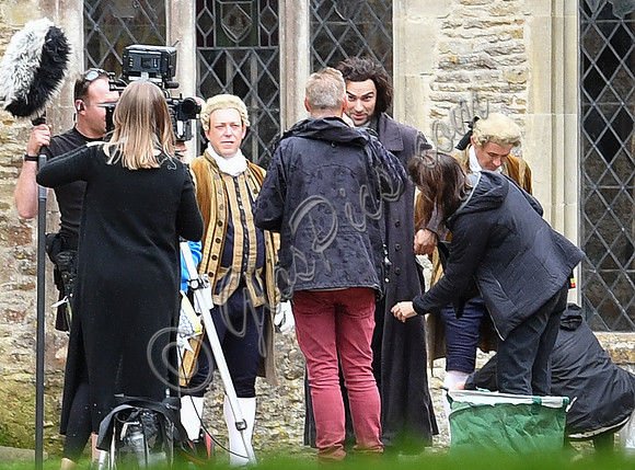 Aidan Turner and crew members in front of Chavenage House