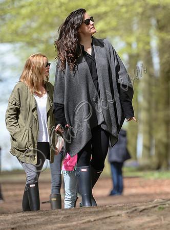 Actress Liv Tyler wearing poncho, skinny jeans and Hunter wellies walking in Oxfordshire