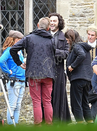 Aidan Turner and crew members in front of Chavenage House