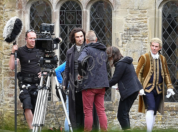 Aidan Turner and crew members in front of Chavenage House
