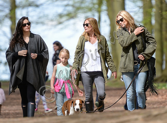 Supermodel Kate Moss wearing military style jacket, skinny jeans and cowboy boots takes a walk with her dog Archie and Liv Tyler who looked cool wearing a poncho teamed with Hunter wellies