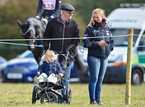 Mia Tindall, groom and family friend watch from outside the arena