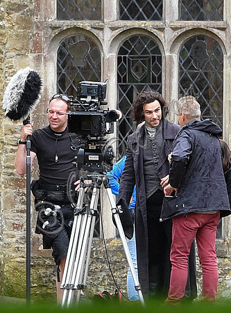 Aidan Turner and crew members in front of Chavenage House
