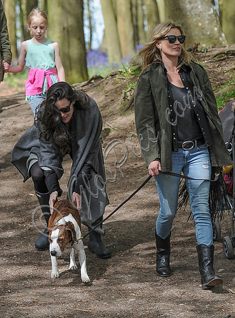 Supermodel Kate Moss wearing military style jacket, skinny jeans and cowboy boots takes a walk with her dog Archie and Liv Tyler who looked cool wearing a poncho teamed with Hunter wellies