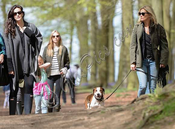 Supermodel Kate Moss wearing military style jacket, skinny jeans and cowboy boots takes a walk with her dog Archie and Liv Tyler who looked cool wearing a poncho teamed with Hunter wellies