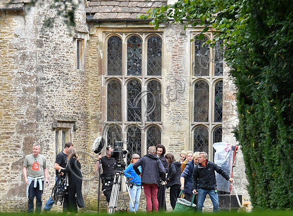 Aidan Turner and crew members in front of Chavenage House