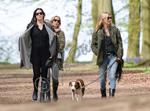 Supermodel Kate Moss wearing military style jacket, skinny jeans and cowboy boots takes a walk with her dog Archie and Liv Tyler who looked cool wearing a poncho teamed with Hunter wellies