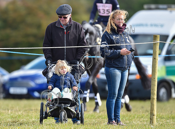 Mia Tindall, groom and family friend watch from outside the arena