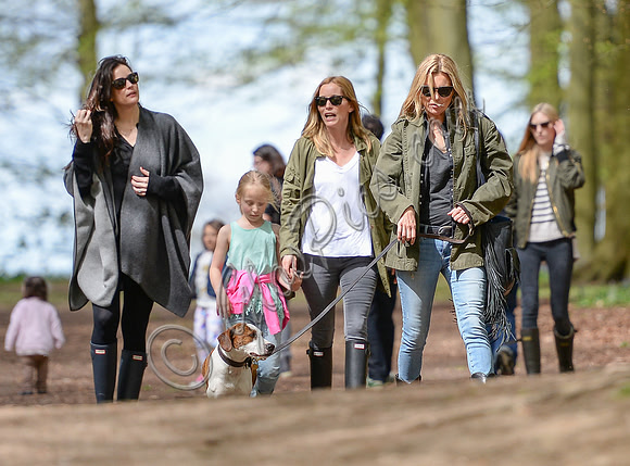 Supermodel Kate Moss wearing military style jacket, skinny jeans and cowboy boots takes a walk with her dog Archie and Liv Tyler who looked cool wearing a poncho teamed with Hunter wellies