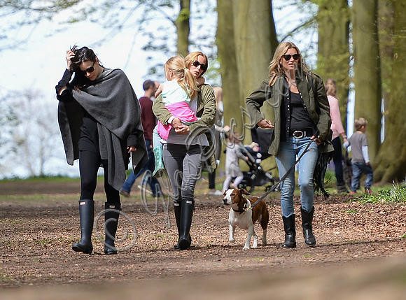 Supermodel Kate Moss wearing military style jacket, skinny jeans and cowboy boots takes a walk with her dog Archie and Liv Tyler who looked cool wearing a poncho teamed with Hunter wellies