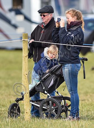 Mia Tindall, groom and family friend watch from outside the arena
